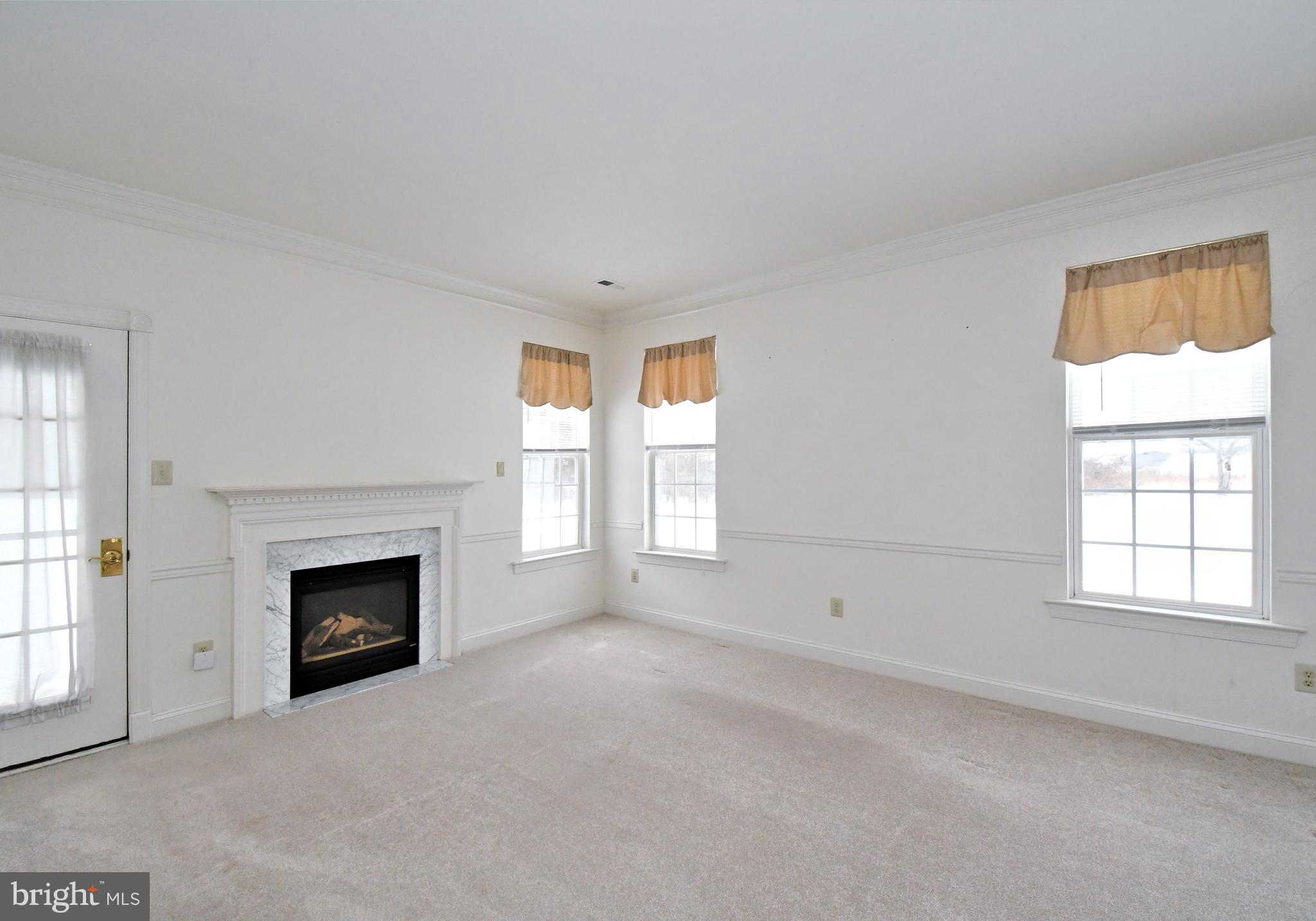 425 Ruth Court Harleysville, PA 19438 - Photo 6 of 26 an empty room with windows and fireplace