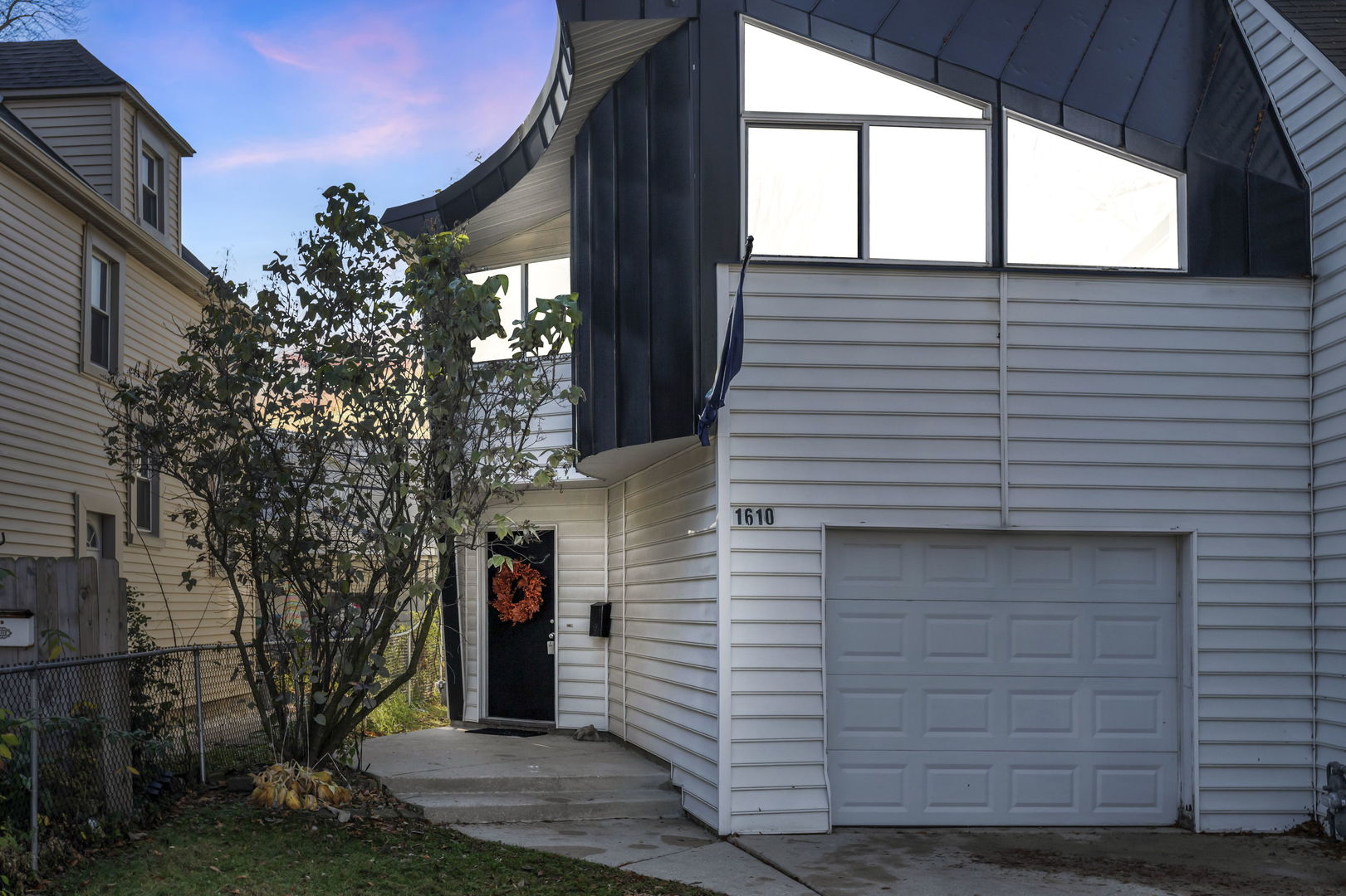 a view of a house with a yard and garage
