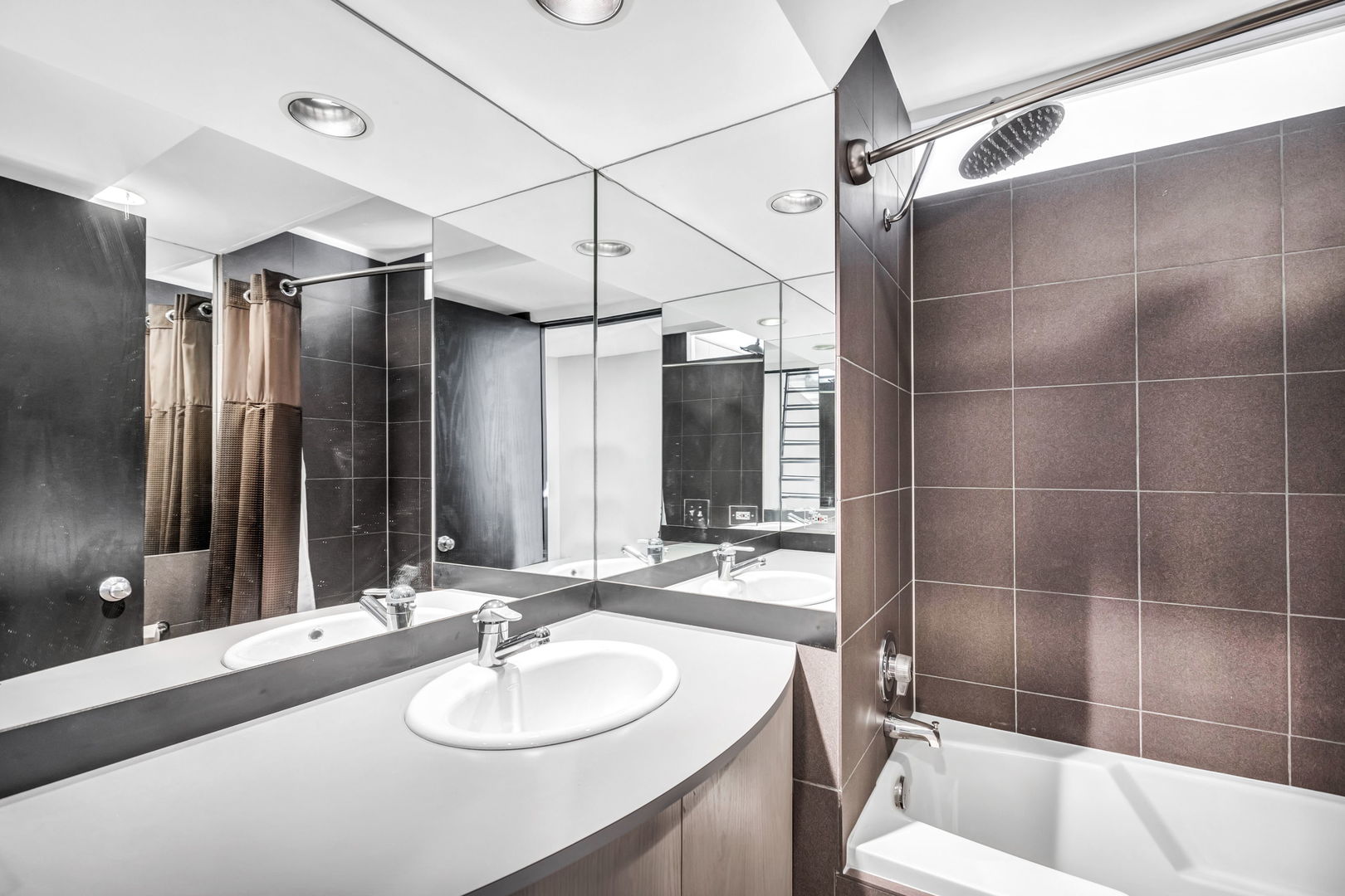 1610 Dempster Street Evanston, IL 60202 - Photo 20 of 28 a bathroom with a sink vanity granite tub shower and a mirror