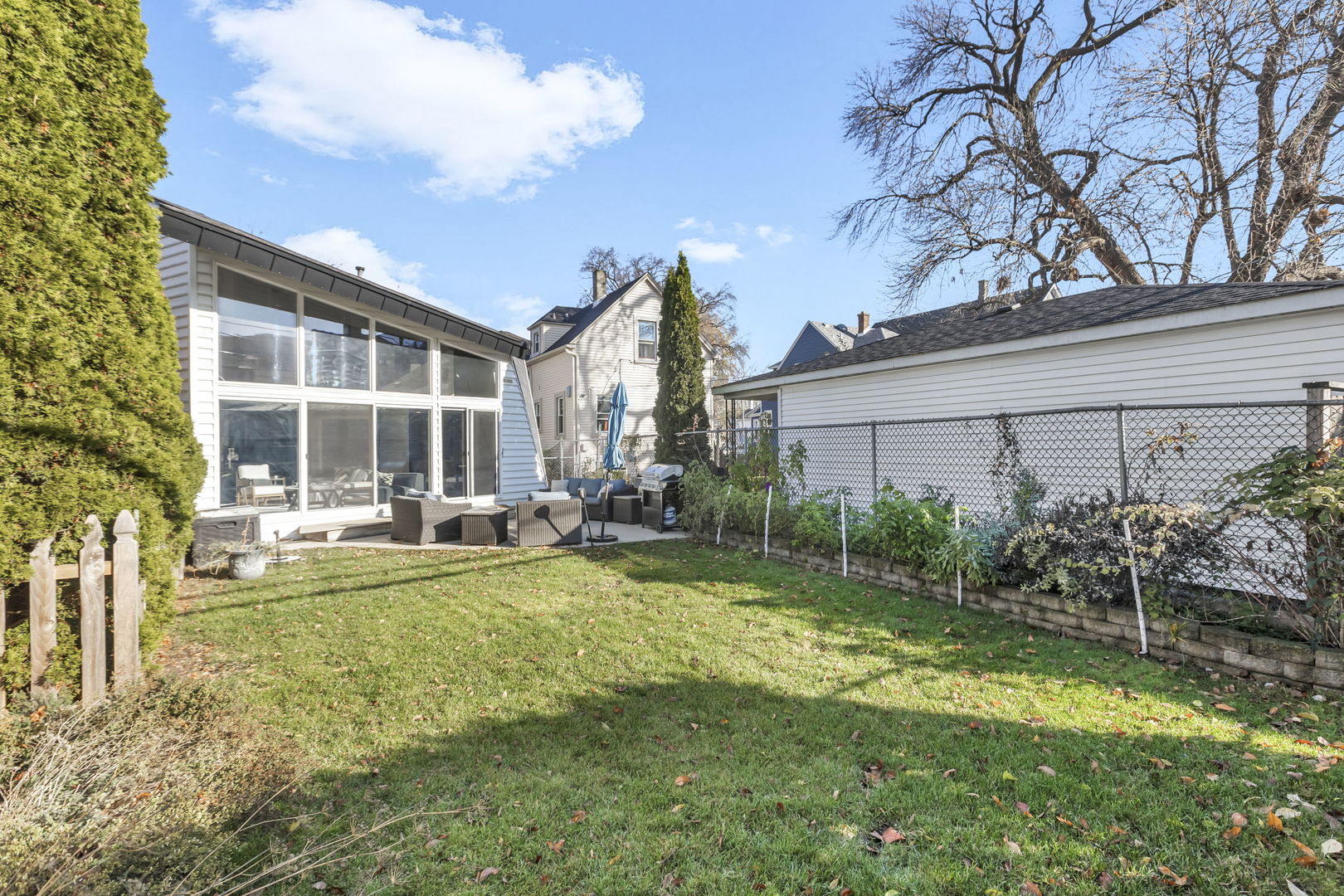 1610 Dempster Street Evanston, IL 60202 - Photo 25 of 28 a view of house with backyard and outdoor seating