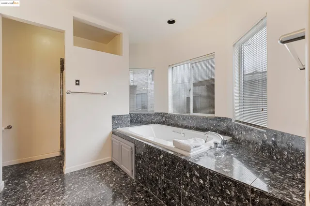 a bedroom with a bed and a night stand