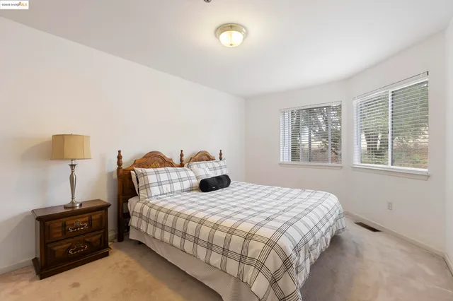 a bedroom with a bed and a tv on table
