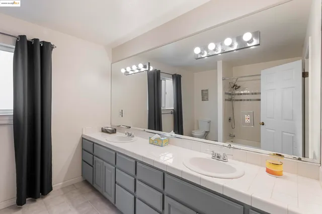 a living room with furniture a bed and a window