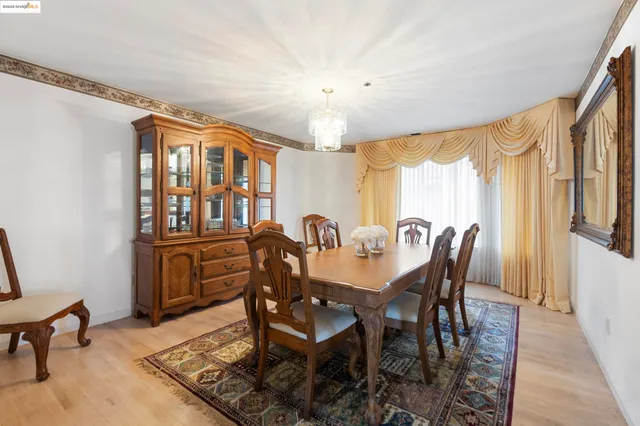 a view of a a dining room with furniture window and wooden floor