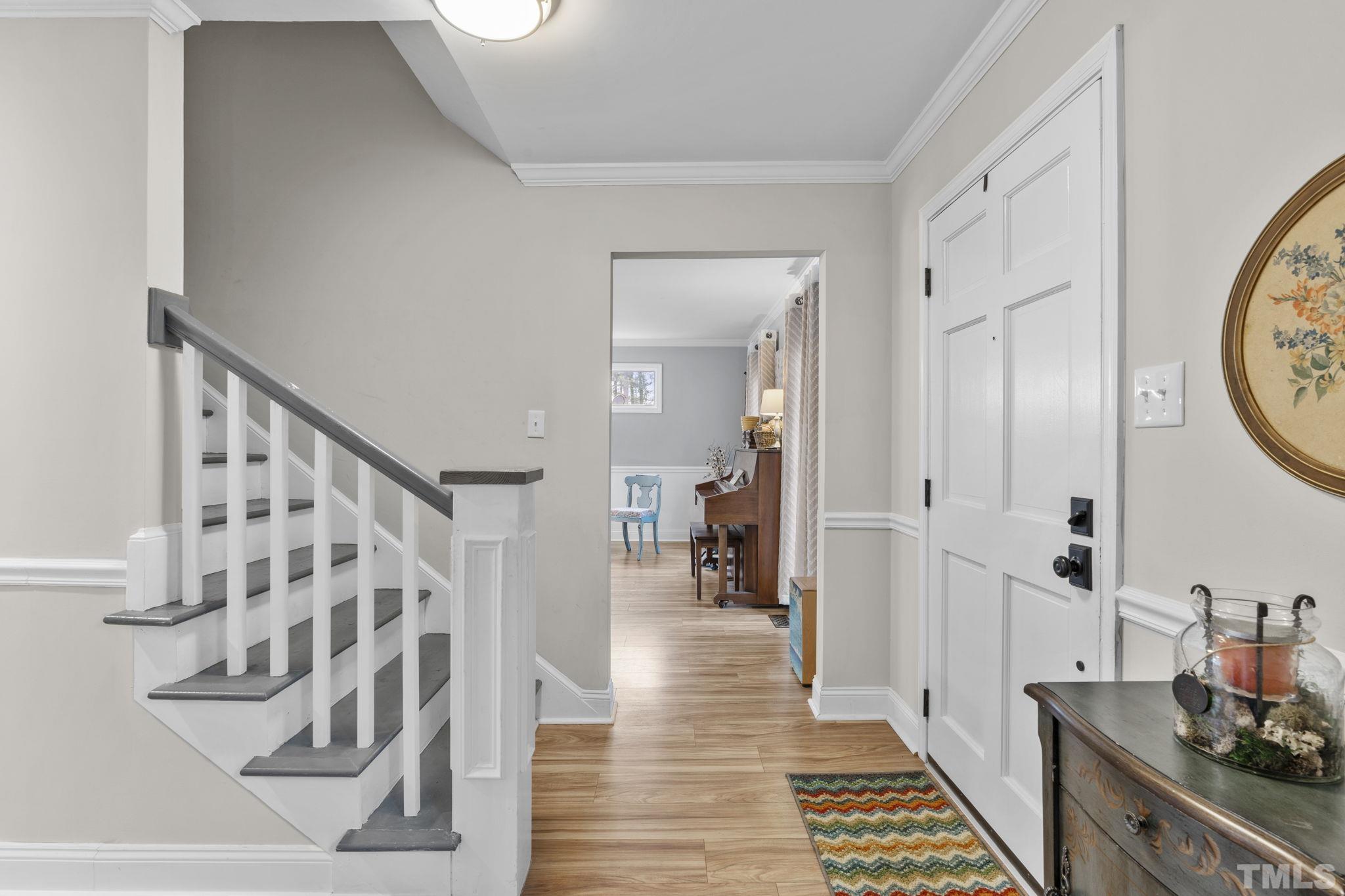 1005 Sawmill Road Raleigh, NC 27615 - Photo 5 of 40 a view of a hallway with wooden floor and staircase