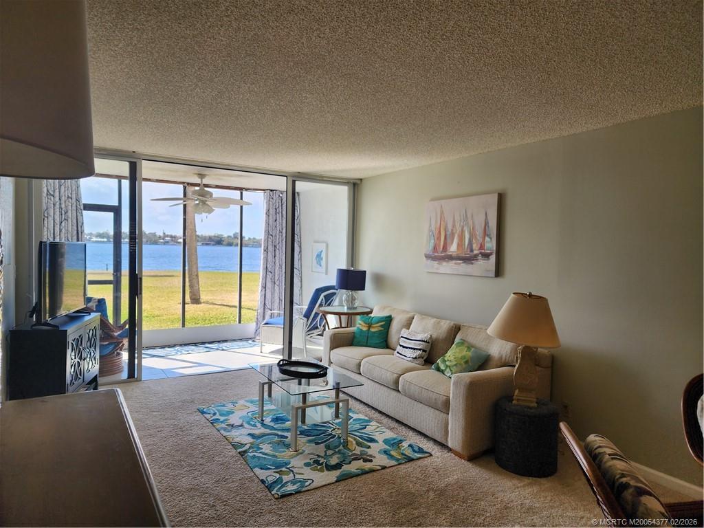 1950 Southwest Palm City Road, Unit 13102 Stuart, FL 34994 - Photo 12 of 40 a living room with furniture and a large window