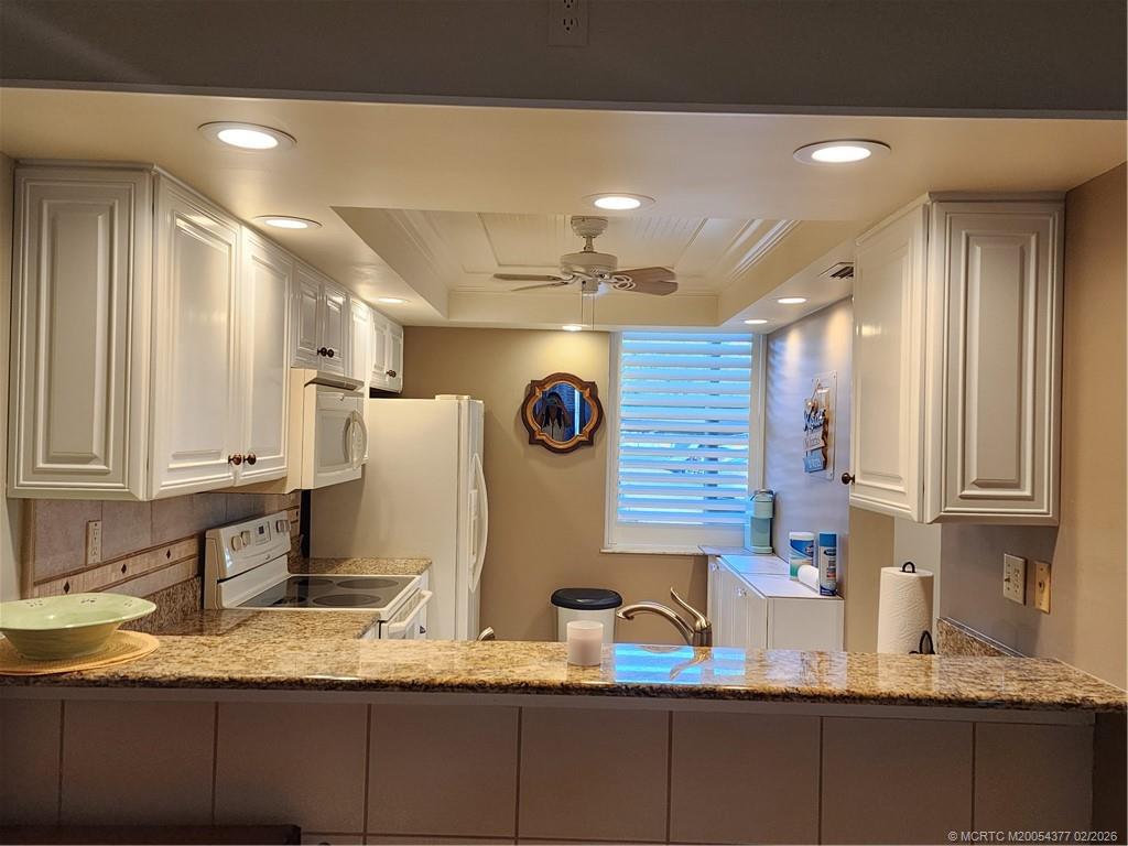 1950 Southwest Palm City Road, Unit 13102 Stuart, FL 34994 - Photo 16 of 40 a bathroom with a granite countertop double vanity sink and a mirror