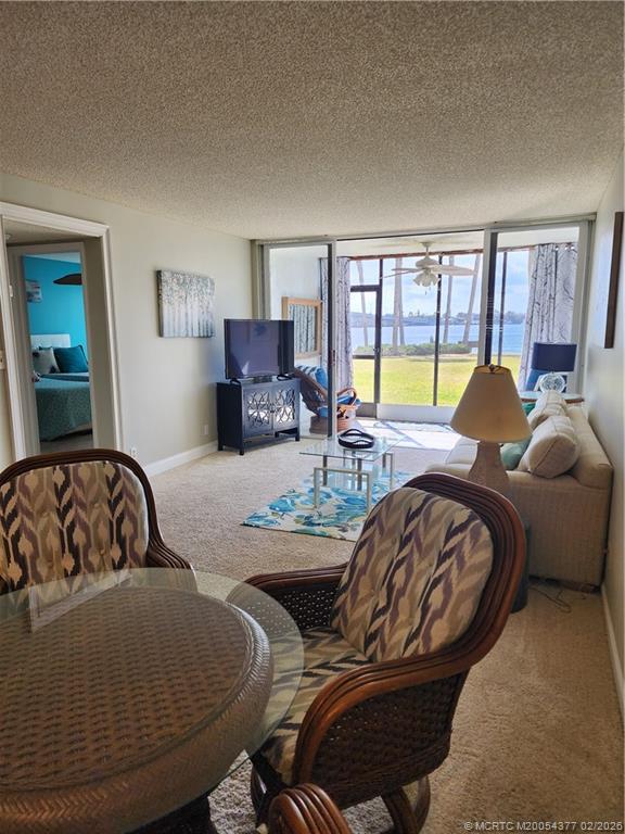 1950 Southwest Palm City Road, Unit 13102 Stuart, FL 34994 - Photo 17 of 40 a living room with furniture and a large window