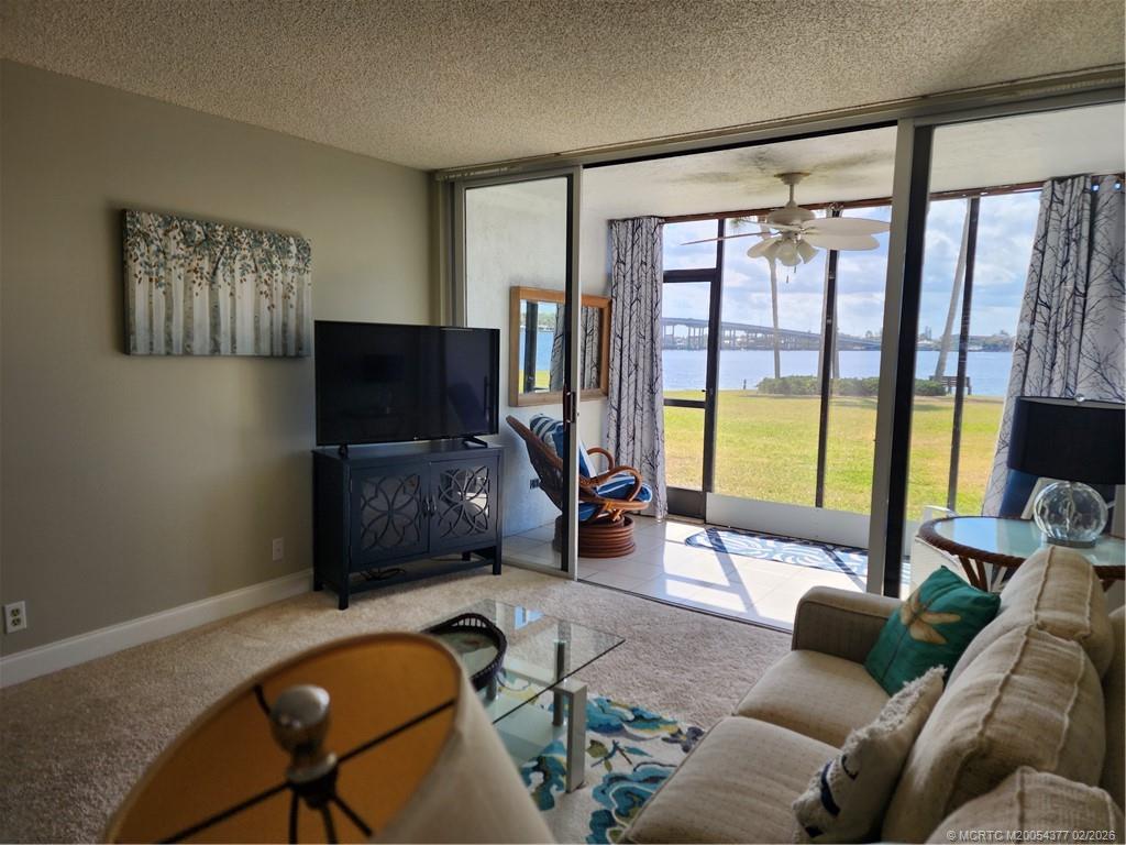 1950 Southwest Palm City Road, Unit 13102 Stuart, FL 34994 - Photo 18 of 40 a living room with furniture and a flat screen tv