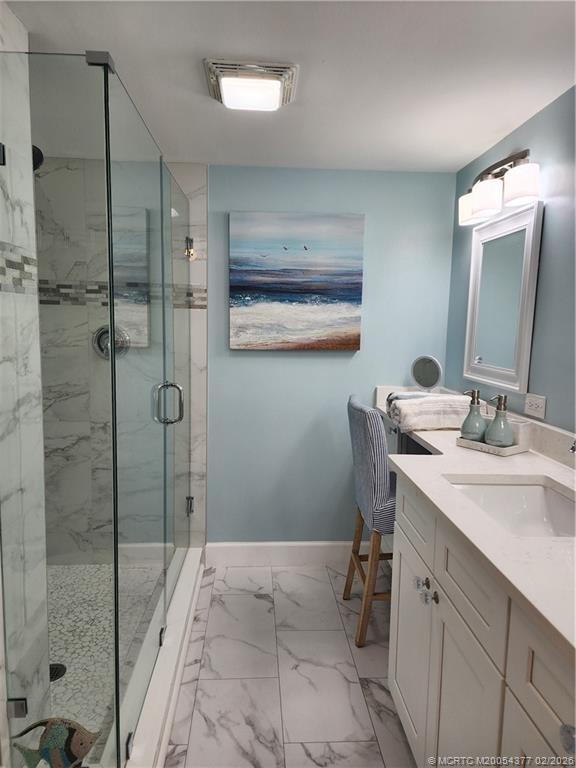 1950 Southwest Palm City Road, Unit 13102 Stuart, FL 34994 - Photo 20 of 40 a bathroom with a granite countertop sink mirror and a bathtub