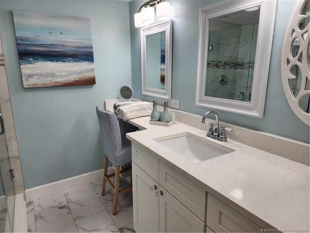 1950 Southwest Palm City Road, Unit 13102 Stuart, FL 34994 - Photo 21 of 40 a bathroom with a sink and a mirror