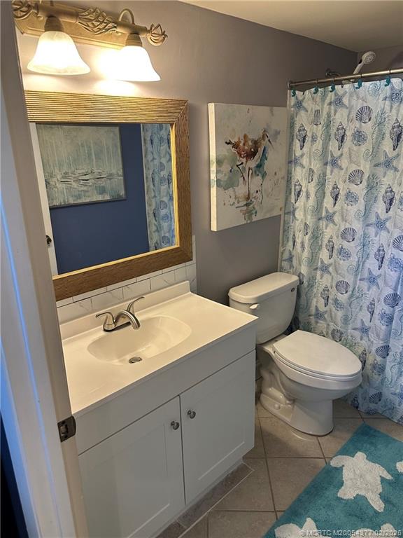 1950 Southwest Palm City Road, Unit 13102 Stuart, FL 34994 - Photo 25 of 40 a bathroom with a toilet sink and mirror