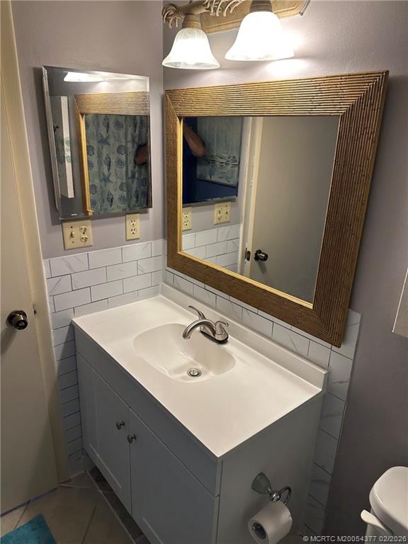 1950 Southwest Palm City Road, Unit 13102 Stuart, FL 34994 - Photo 27 of 40 a bathroom with a sink mirror vanity and toilet