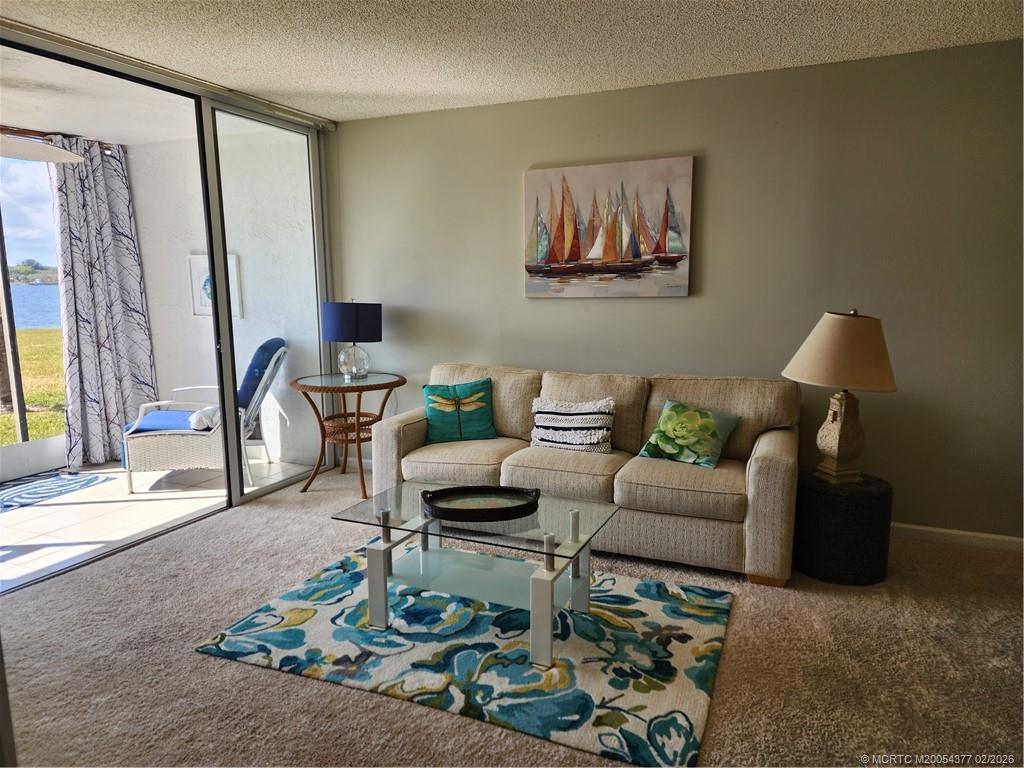 1950 Southwest Palm City Road, Unit 13102 Stuart, FL 34994 - Photo 30 of 40 a living room with furniture and a potted plant