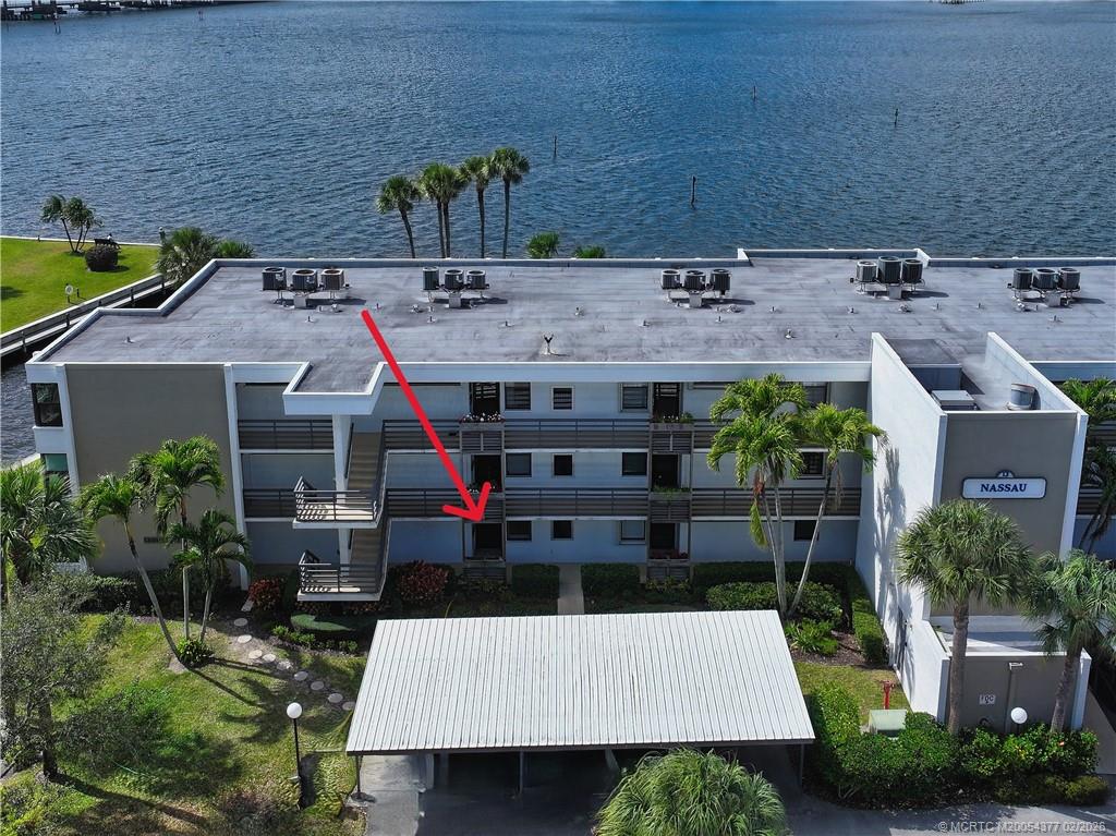 1950 Southwest Palm City Road, Unit 13102 Stuart, FL 34994 - Photo 5 of 40 an aerial view of a house with swimming pool and garden