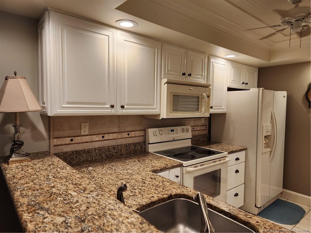 1950 Southwest Palm City Road, Unit 13102 Stuart, FL 34994 - Photo 10 of 40 a kitchen with refrigerator and cabinets