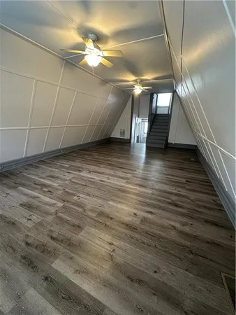 a view of a room with wooden floor