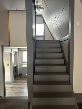 a view of entryway and hall with wooden floor