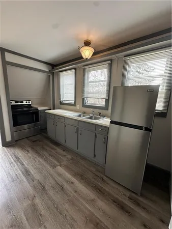 a kitchen with a refrigerator and a sink