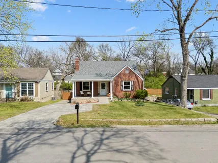 a view of a dining room with furniture and a potted plant