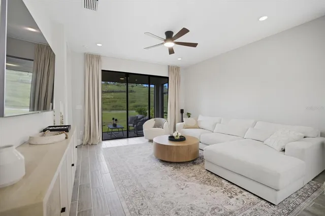 a living room with furniture and a large window