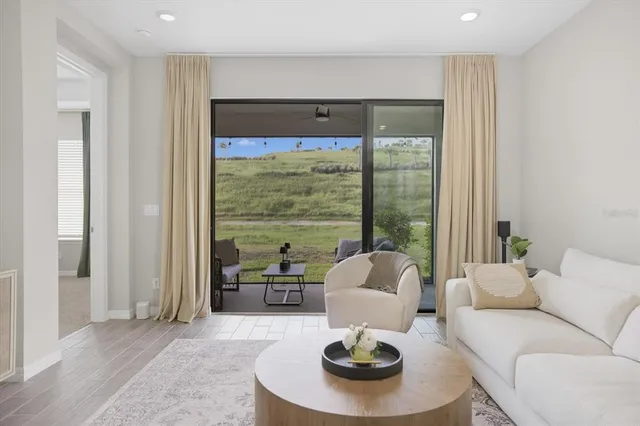 a living room with furniture and a large window