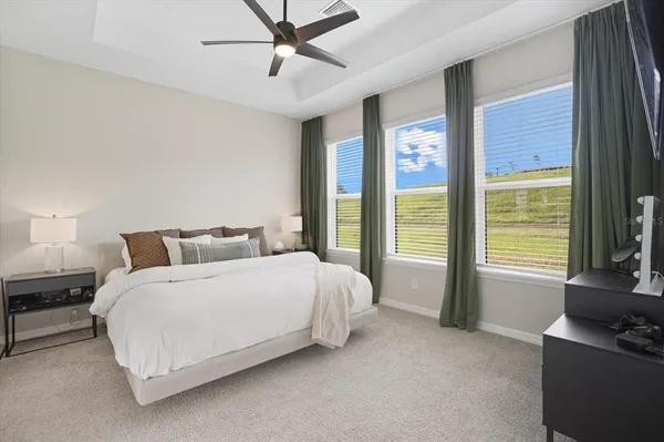 a spacious bedroom with a bed and a couch