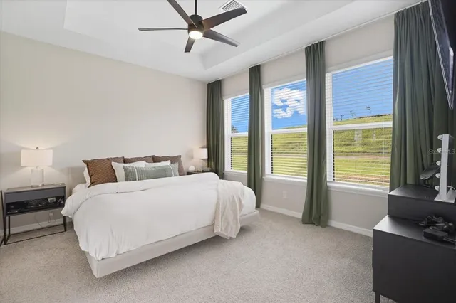 a spacious bedroom with a bed and a couch