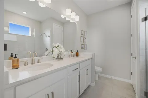 a bathroom with a double vanity sink and a mirror