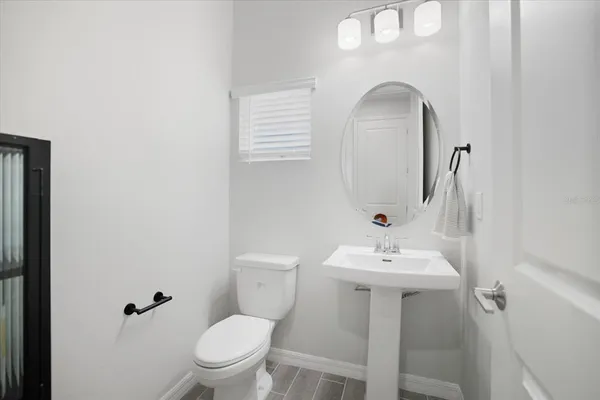 a bathroom with a sink mirror and toilet