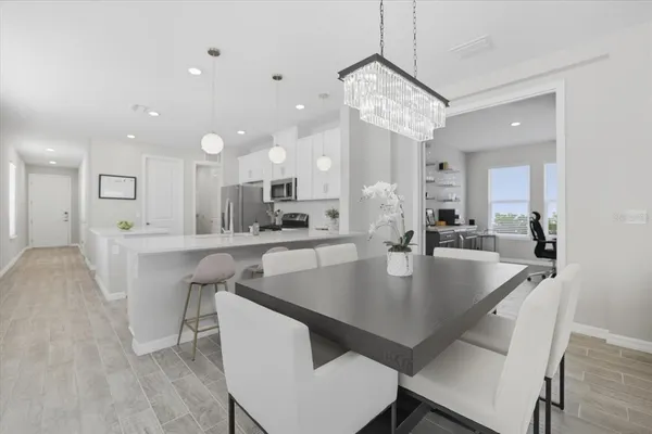 a view of kitchen and dining area with a table chairs