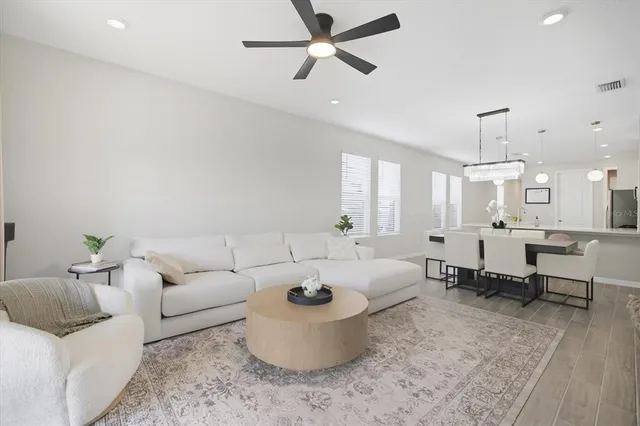 a living room with furniture and a chandelier