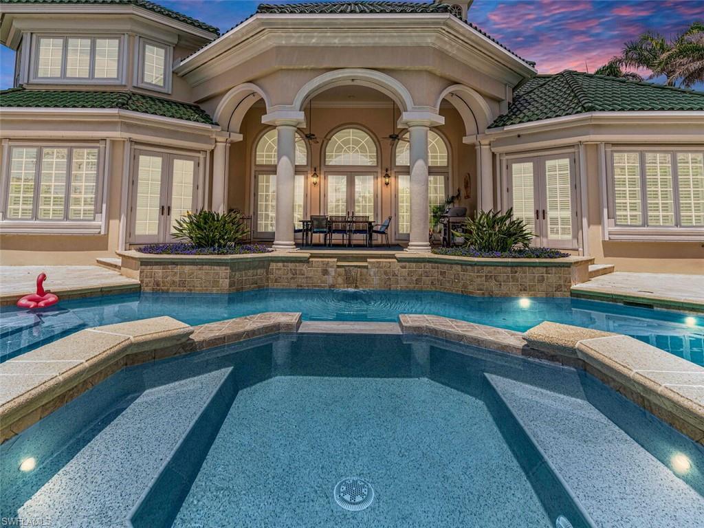 a front view of house with outdoor space and swimming pool