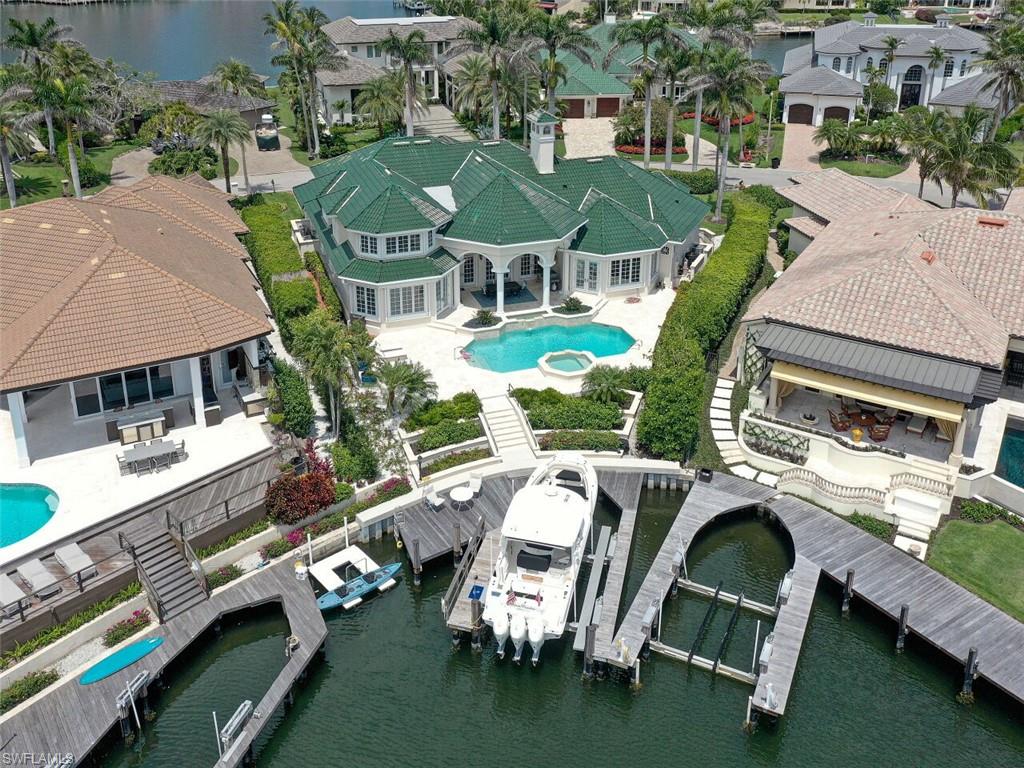 330 Devils Bight Naples, FL 34103 - Photo 17 of 47 an aerial view of a house with swimming pool patio and outdoor seating