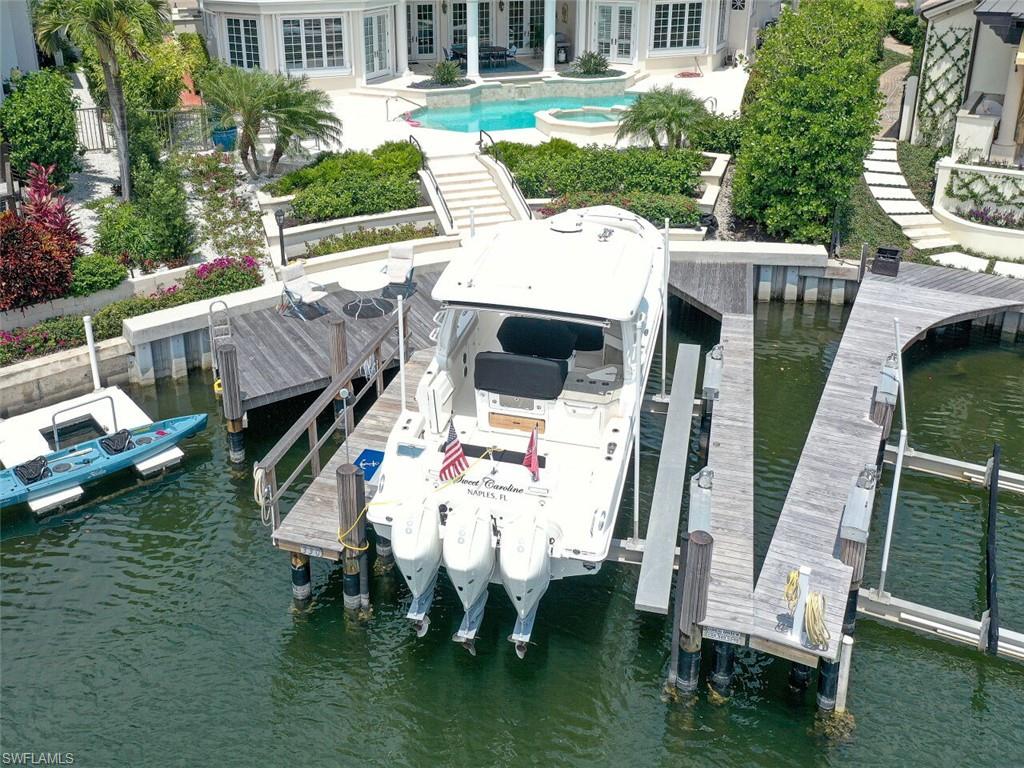 330 Devils Bight Naples, FL 34103 - Photo 18 of 47 a view of yard with patio and outdoor seating