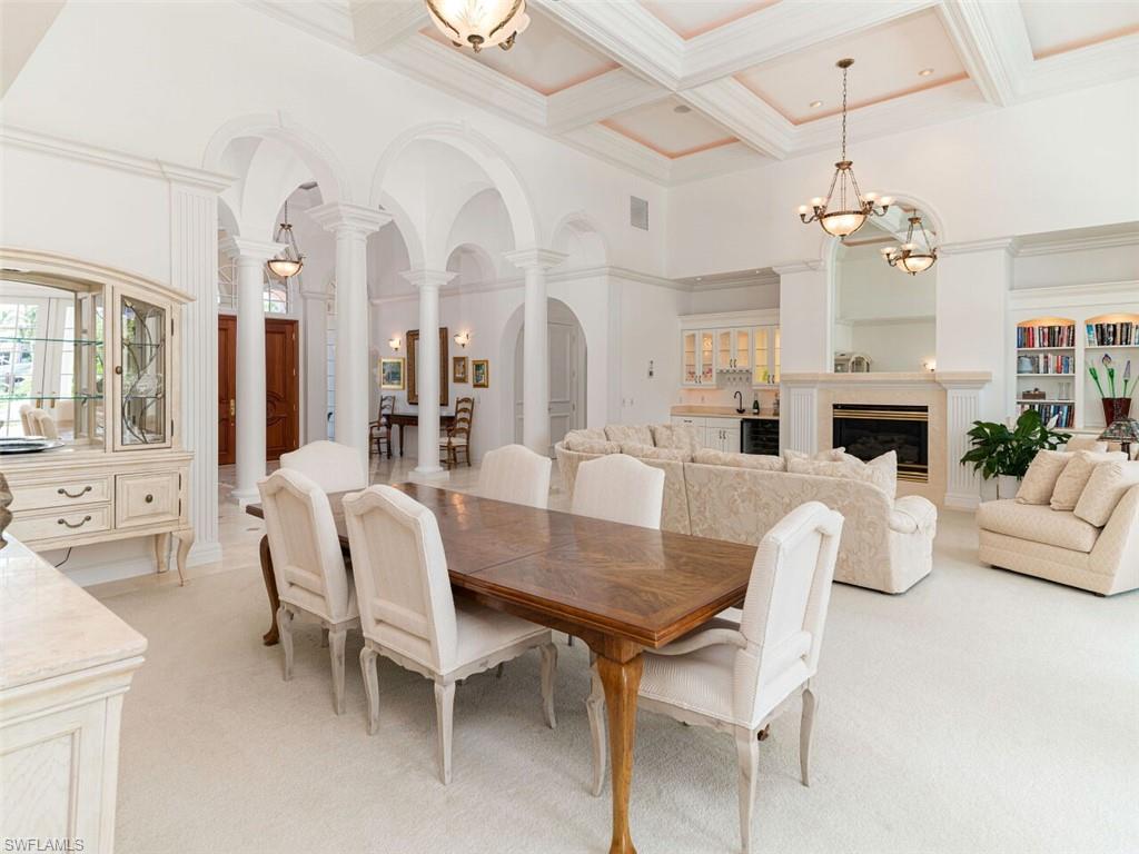 330 Devils Bight Naples, FL 34103 - Photo 24 of 47 a view of a dining room with furniture and a fireplace