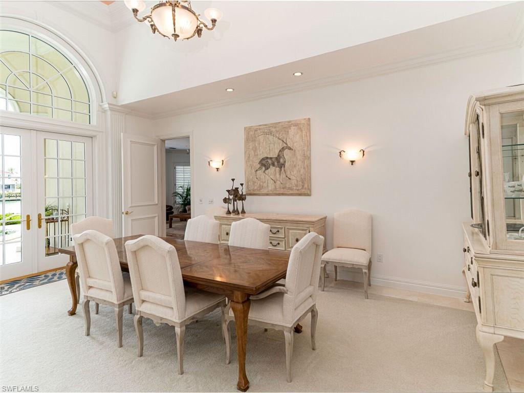 330 Devils Bight Naples, FL 34103 - Photo 25 of 47 a view of a dining room with furniture and a chandelier