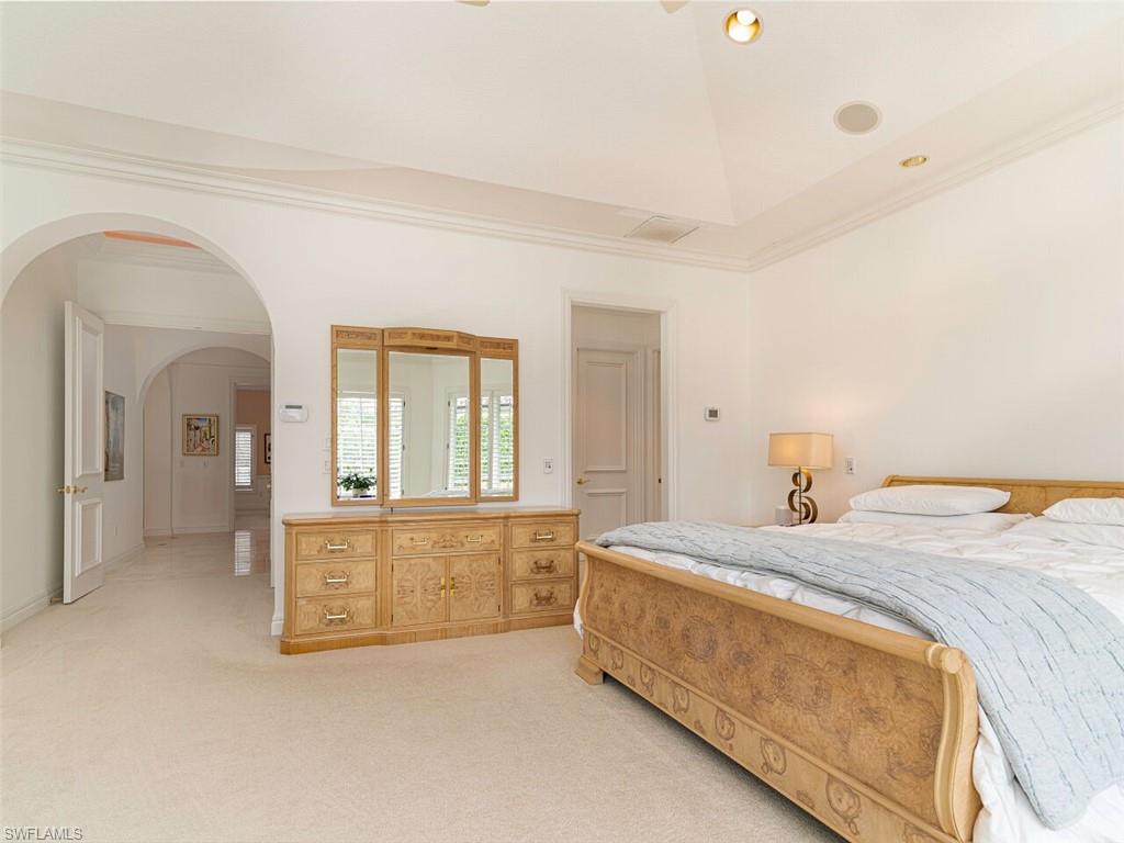 330 Devils Bight Naples, FL 34103 - Photo 29 of 47 a spacious bedroom with a bed and a cabinets