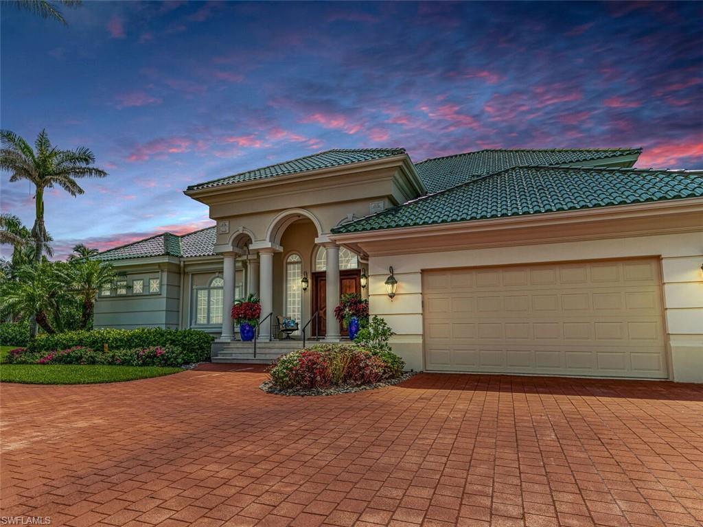 330 Devils Bight Naples, FL 34103 - Photo 3 of 47 a front view of a house with a yard and potted plants