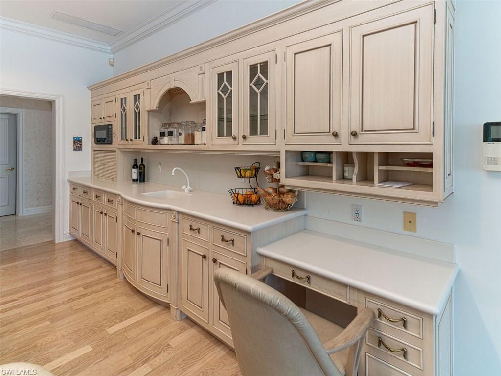 330 Devils Bight Naples, FL 34103 - Photo 39 of 47 a kitchen with cabinets a sink and appliances