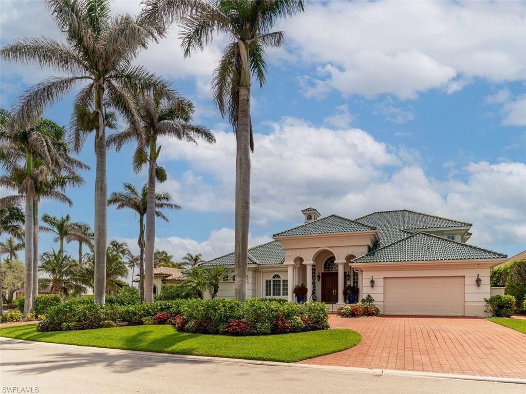 330 Devils Bight Naples, FL 34103 - Photo 4 of 47 a front view of a house with a garden and trees