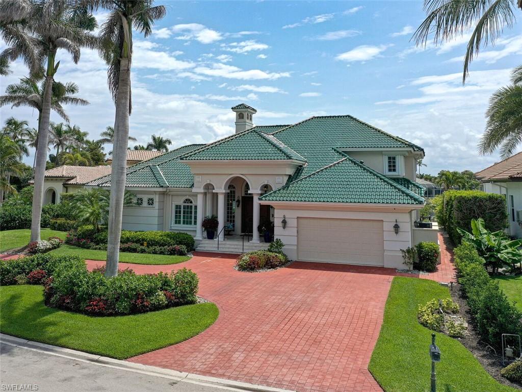330 Devils Bight Naples, FL 34103 - Photo 6 of 47 a front view of a house with garden