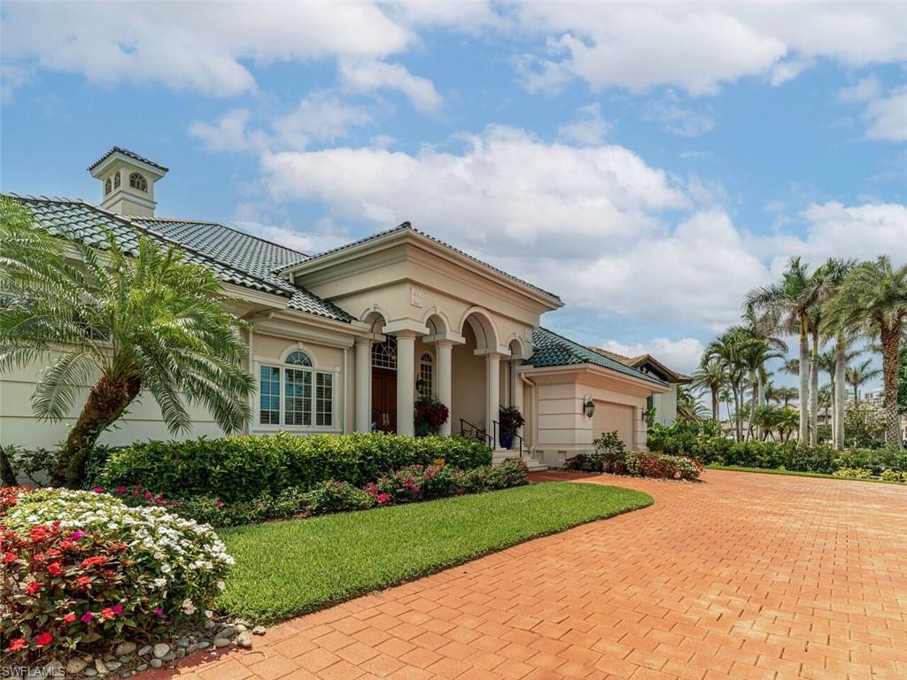 330 Devils Bight Naples, FL 34103 - Photo 7 of 47 a front view of a house with garden