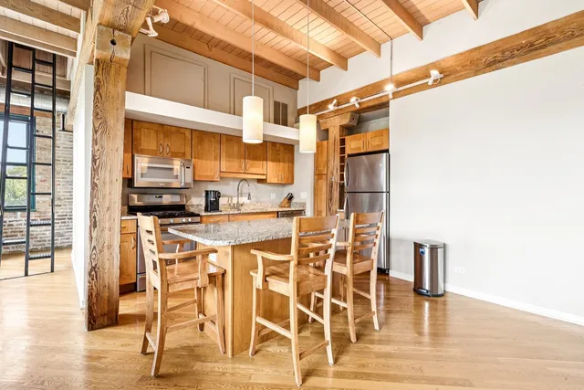 a kitchen with granite countertop a sink stove top oven and cabinets