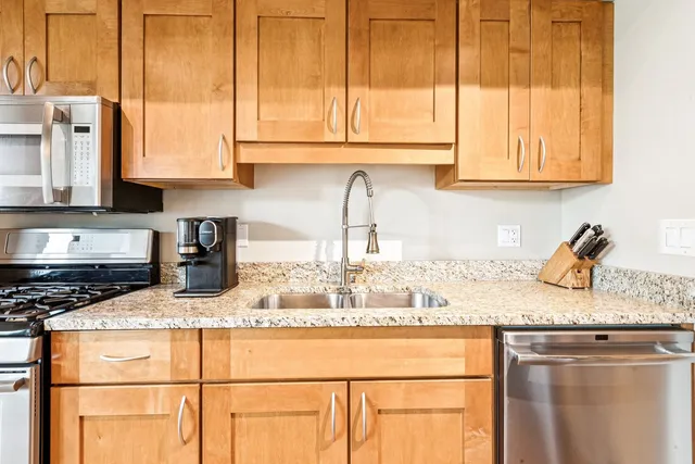 a stove top oven sitting inside of a kitchen