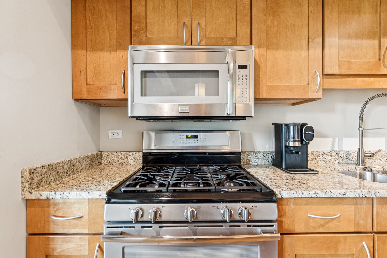 3201 North Ravenswood Avenue, Unit 301 Chicago, IL 60657 - Photo 15 of 38 a stove top oven sitting inside of a kitchen