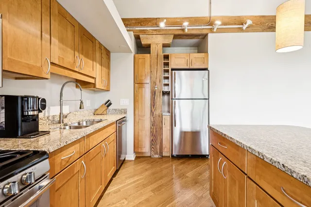 a kitchen with a sink and a stove next to a large window