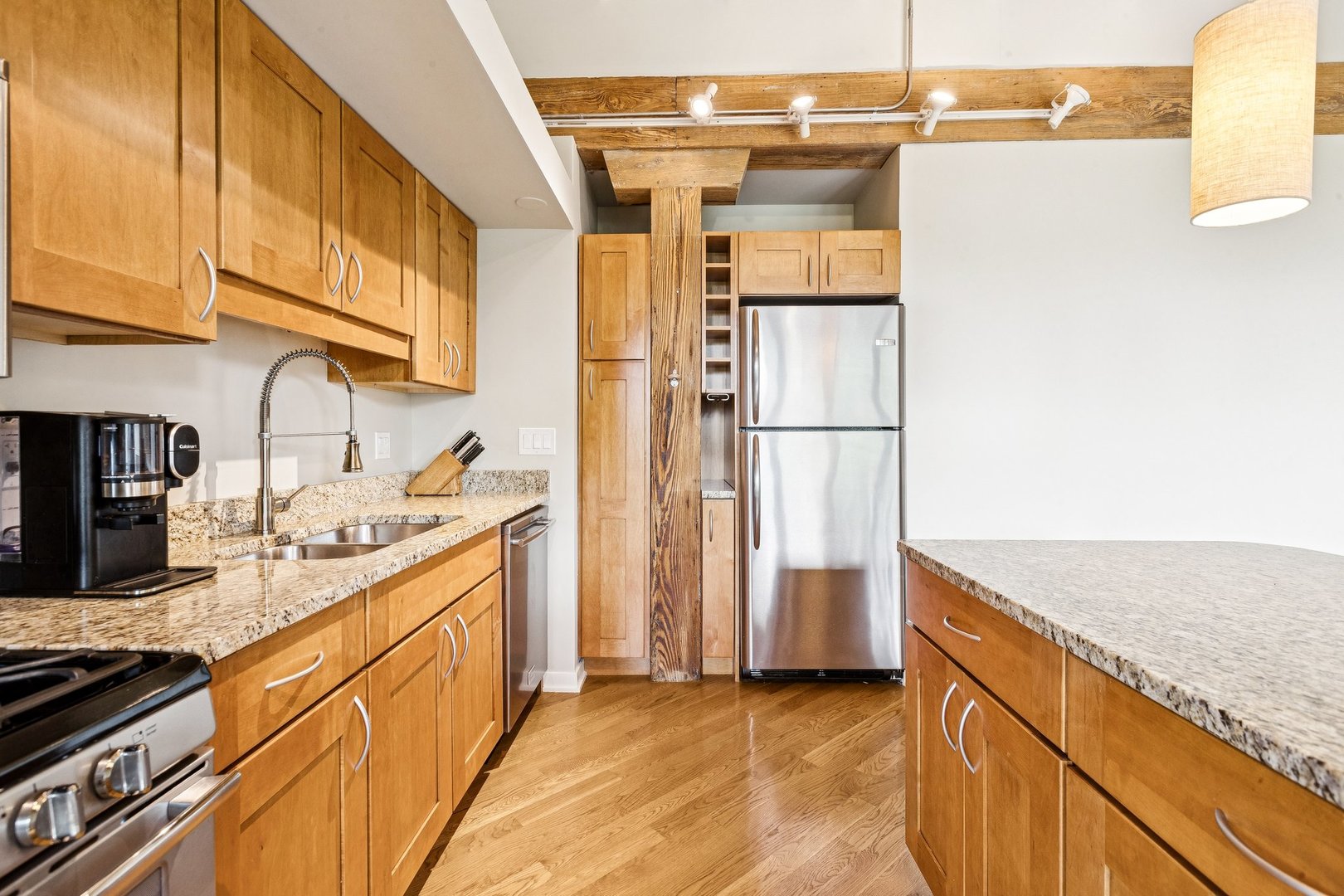 3201 North Ravenswood Avenue, Unit 301 Chicago, IL 60657 - Photo 16 of 38 a kitchen with stainless steel appliances granite countertop a stove a refrigerator and a sink