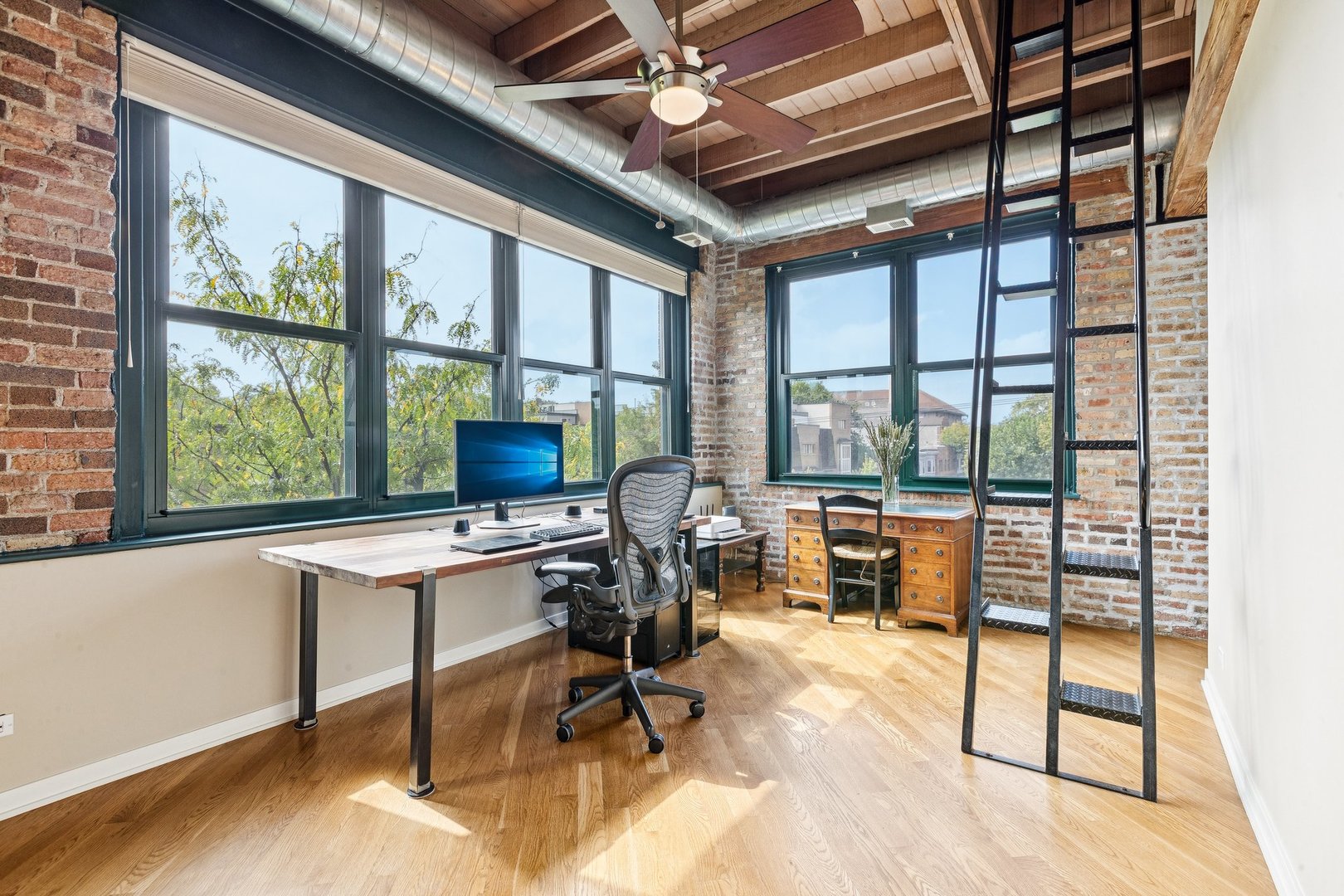 3201 North Ravenswood Avenue, Unit 301 Chicago, IL 60657 - Photo 18 of 38 a view of a workspace with furniture and a window