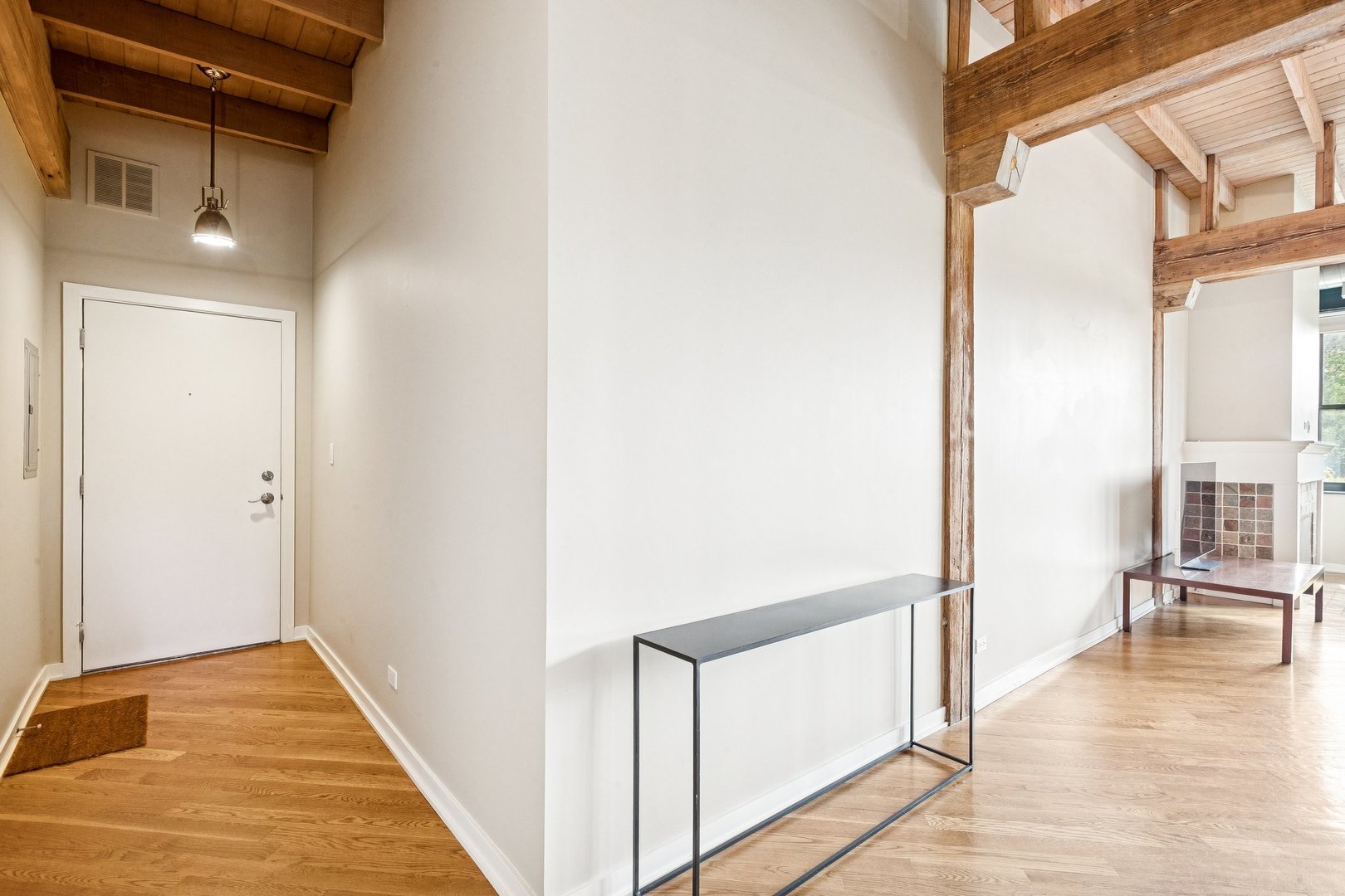 3201 North Ravenswood Avenue, Unit 301 Chicago, IL 60657 - Photo 22 of 38 a view of a hallway with wooden floor and staircase